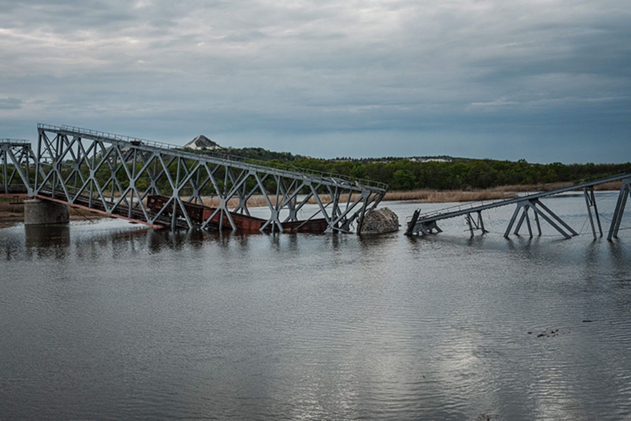 This photograph taken on April 29, 2022 shows a railway bridge, over the Siverskyi Donets river, destroyed by a missile strike according to Ukrainian soldiers, in Raygorodok, eastern Ukraine. 