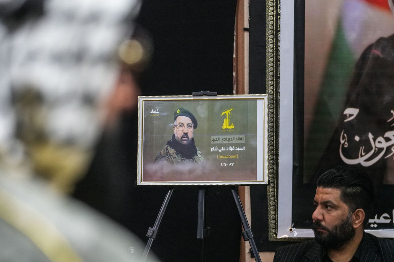 A portrait of Fu'ad Shukr is displayed during a vigil in Najaf, Iraq, on Thursday.