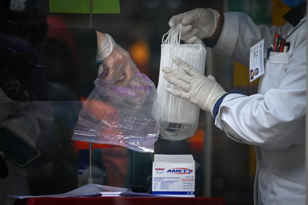 A woman buys face masks at a pharmacy in Beijing.