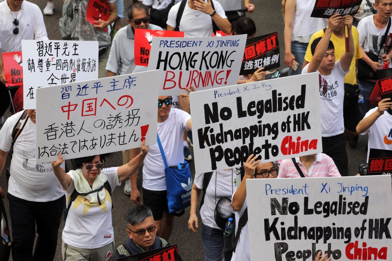 Demonstrators hold placards during a protest against a proposed extradition law in Hong Kong.