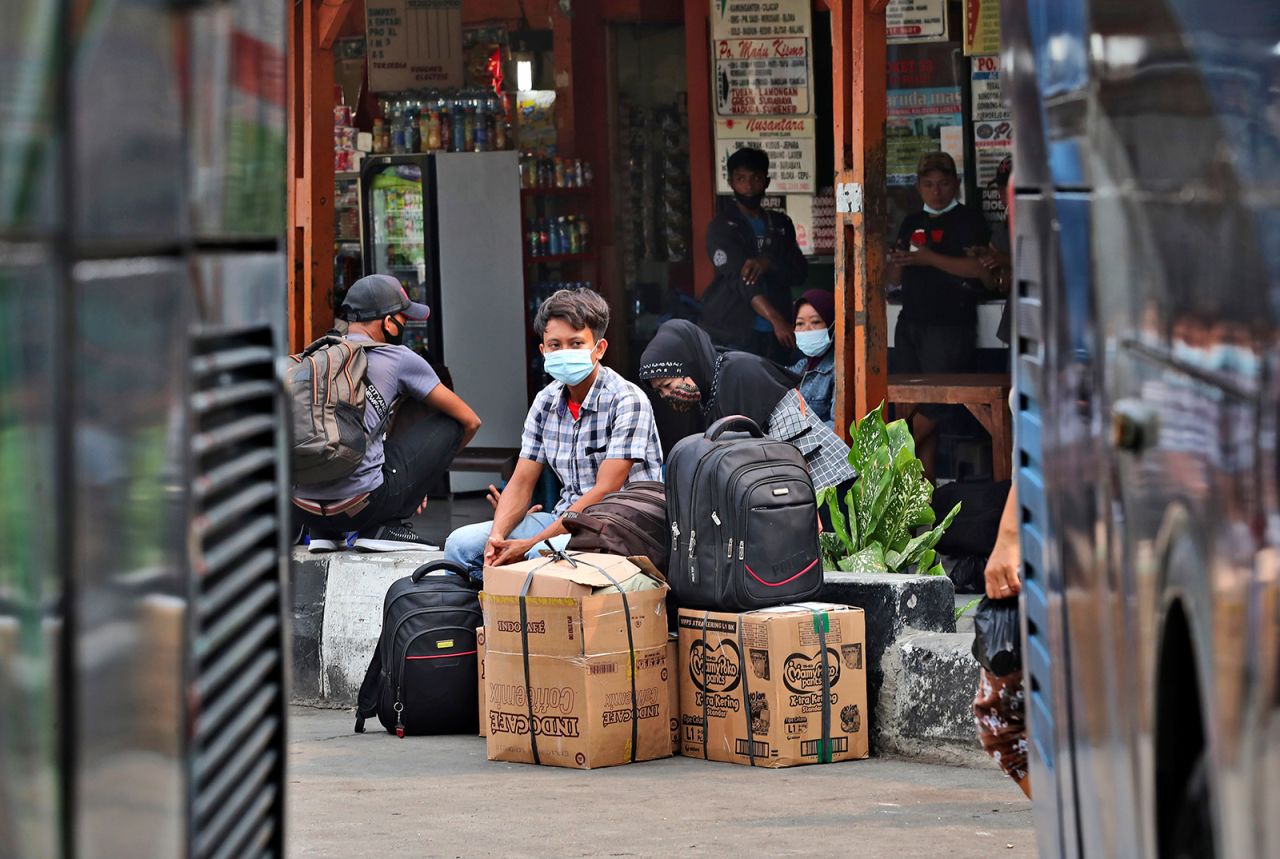 People wait for a bus to take them to their home villages at the Kalideres bus terminal in Jakarta, Indonesia, on May 5.