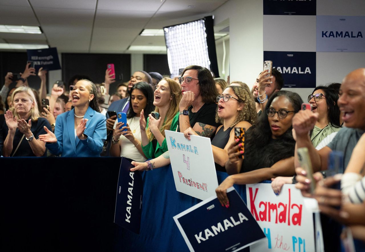 Campaign staff cheer for US Vice President Kamala Harris's first visit to her Presidential Campaign headquarters in Wilmington, Delaware on July 22, 2024. 