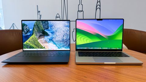 (L, R) Dell XPS 14 with a landscape wallpaper next to Apple MacBook Pro 14 with a wavy color wallpaper