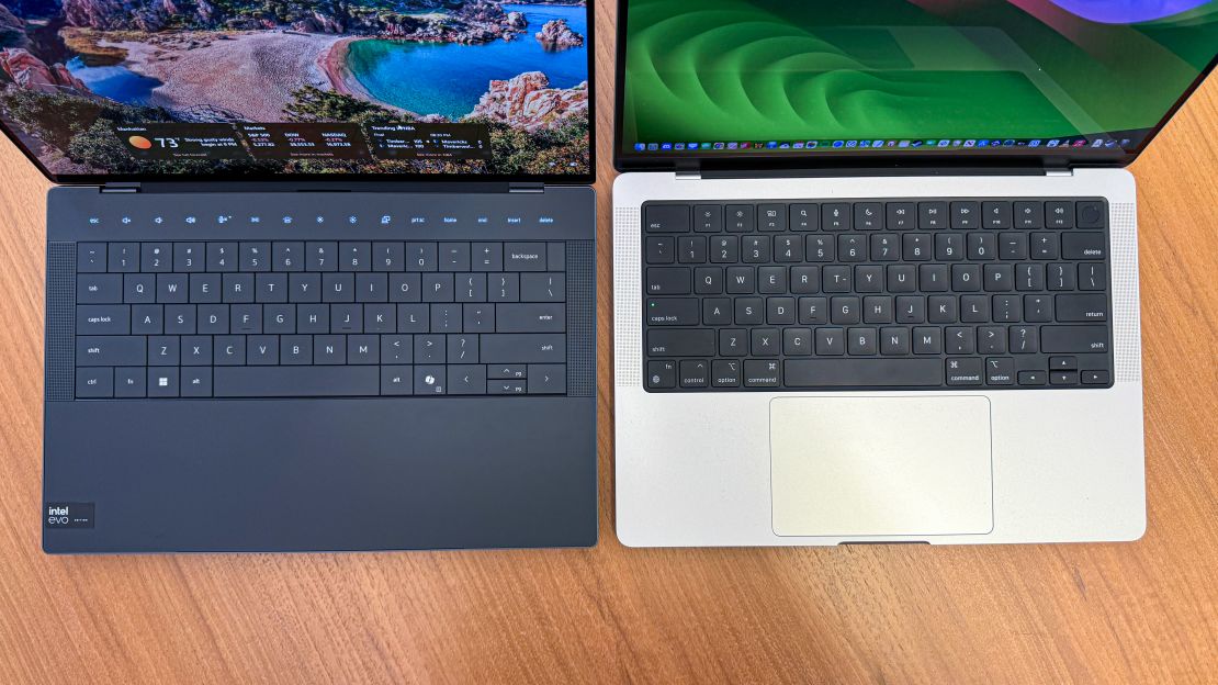 (l, r) Dell XPS 14 with function row keys glowing and screen on next to Apple MacBook Pro 14 turned on