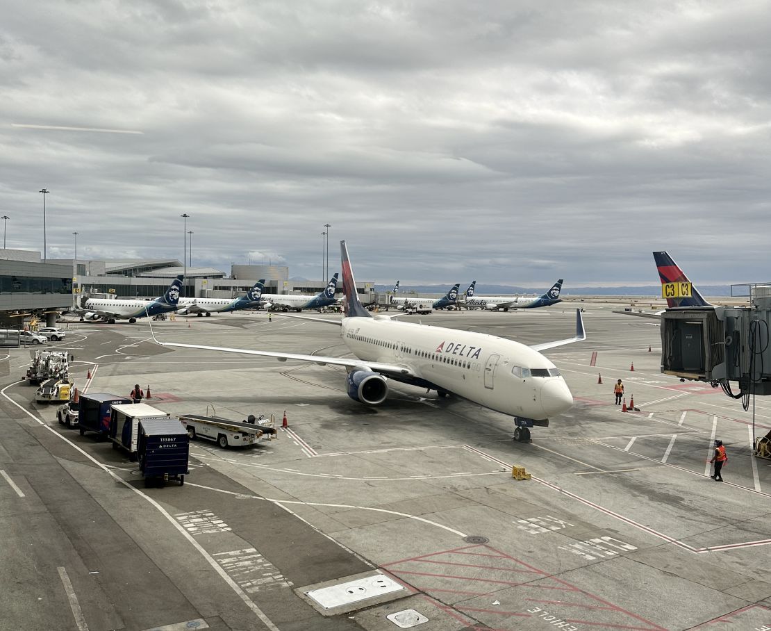 A photo of a Delta Air Lines Boeing 737 pulling out of a gate at San Francisco International Airport (SFO)