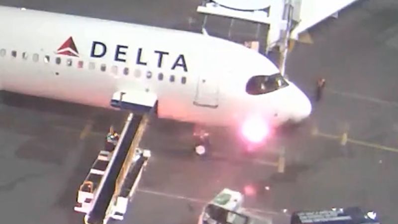 Passengers flee down emergency slides after Delta plane catches fire