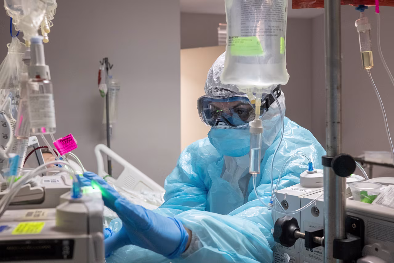 A medical staff member checks an I.V. pump for a patient in the Covid-19 intensive care unit (ICU) at the United Memorial Medical Center in Houston, Texas, on December 10.