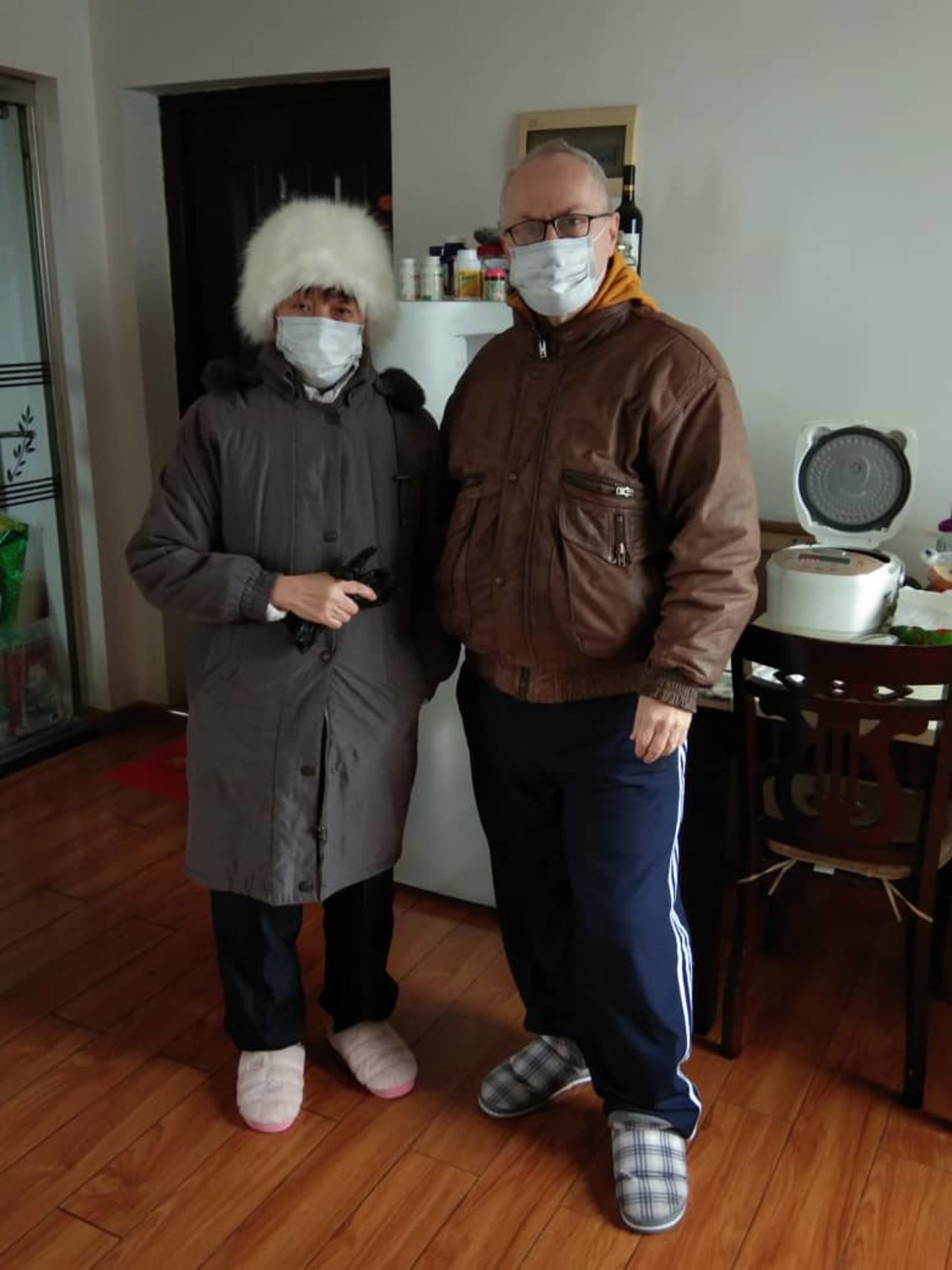 Wayne Dupleiss (right) in his home in Wuhan. 