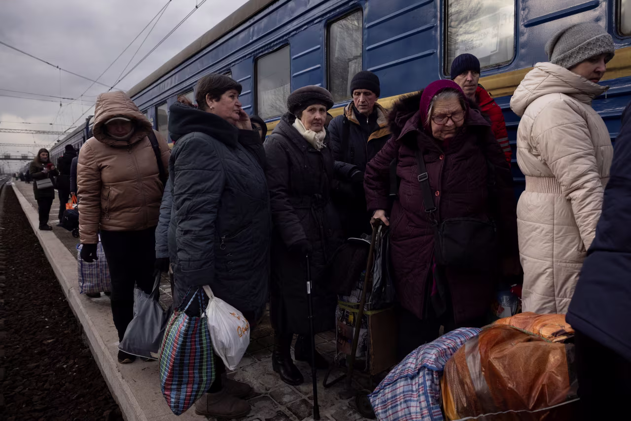 People wait to board an evacuation train in Pokrovsk after an increase of Russian missile strikes in the area around Avdiivka, Ukraine, on Tuesday. 