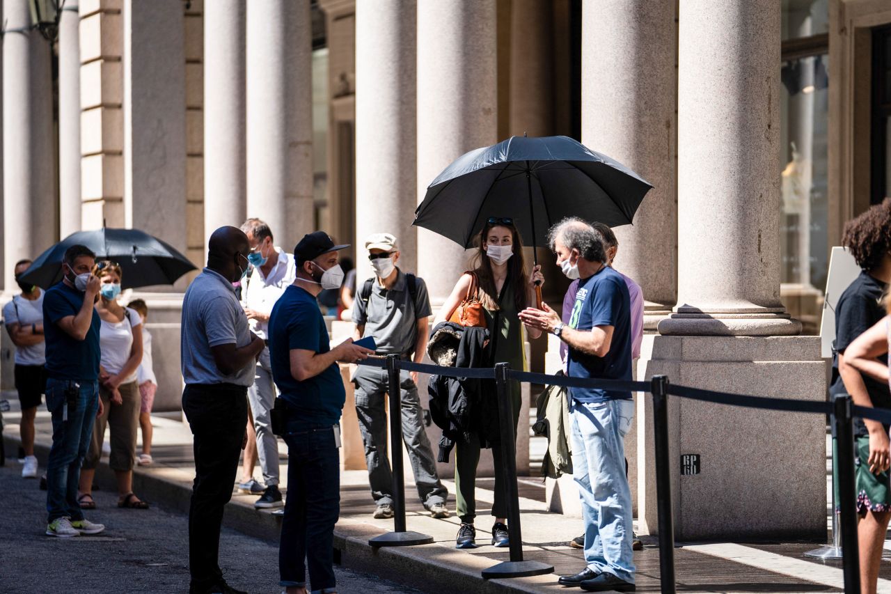 Pedestrians adopt a safe social distance as they stand in line outside an Apple Inc. store in Turin, Italy, on June 23.