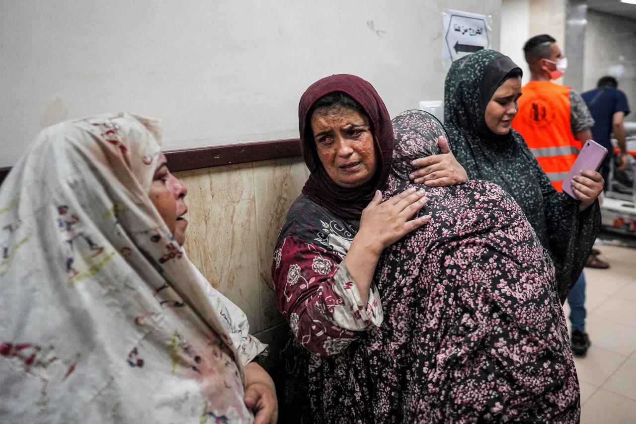 Women embrace in a corridor at Al-Aqsa Martyrs hospital in Deir el-Balah on June 4. 