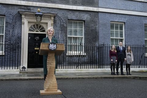 Outgoing British Prime Minister Liz Truss, left, speaks outside Downing Street in London, Tuesday, October 25, 2022 as her husband Hugh O'Leary and daughters Frances and Liberty look on.