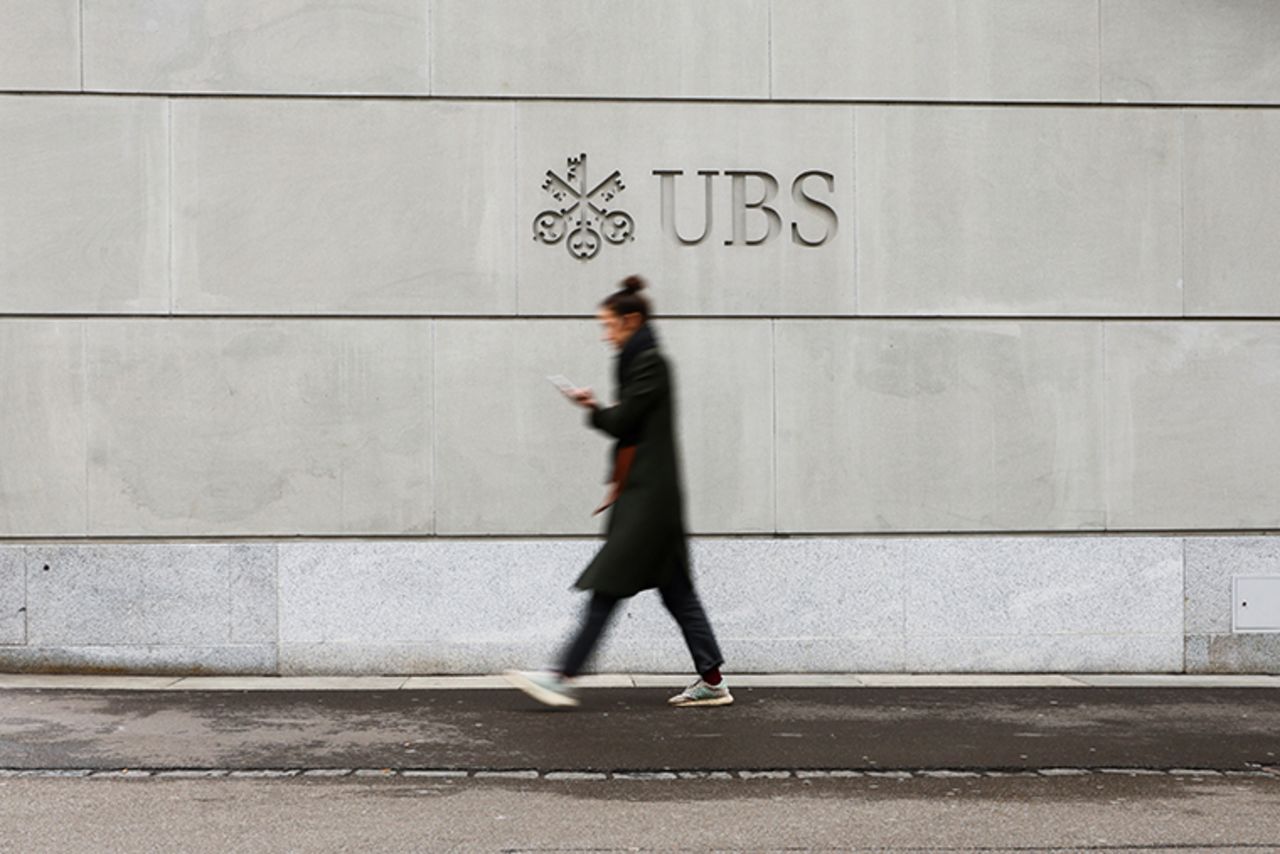 A person walks in front of a logo of the Swiss bank?UBS?in Zurich, Switzerland March 20.