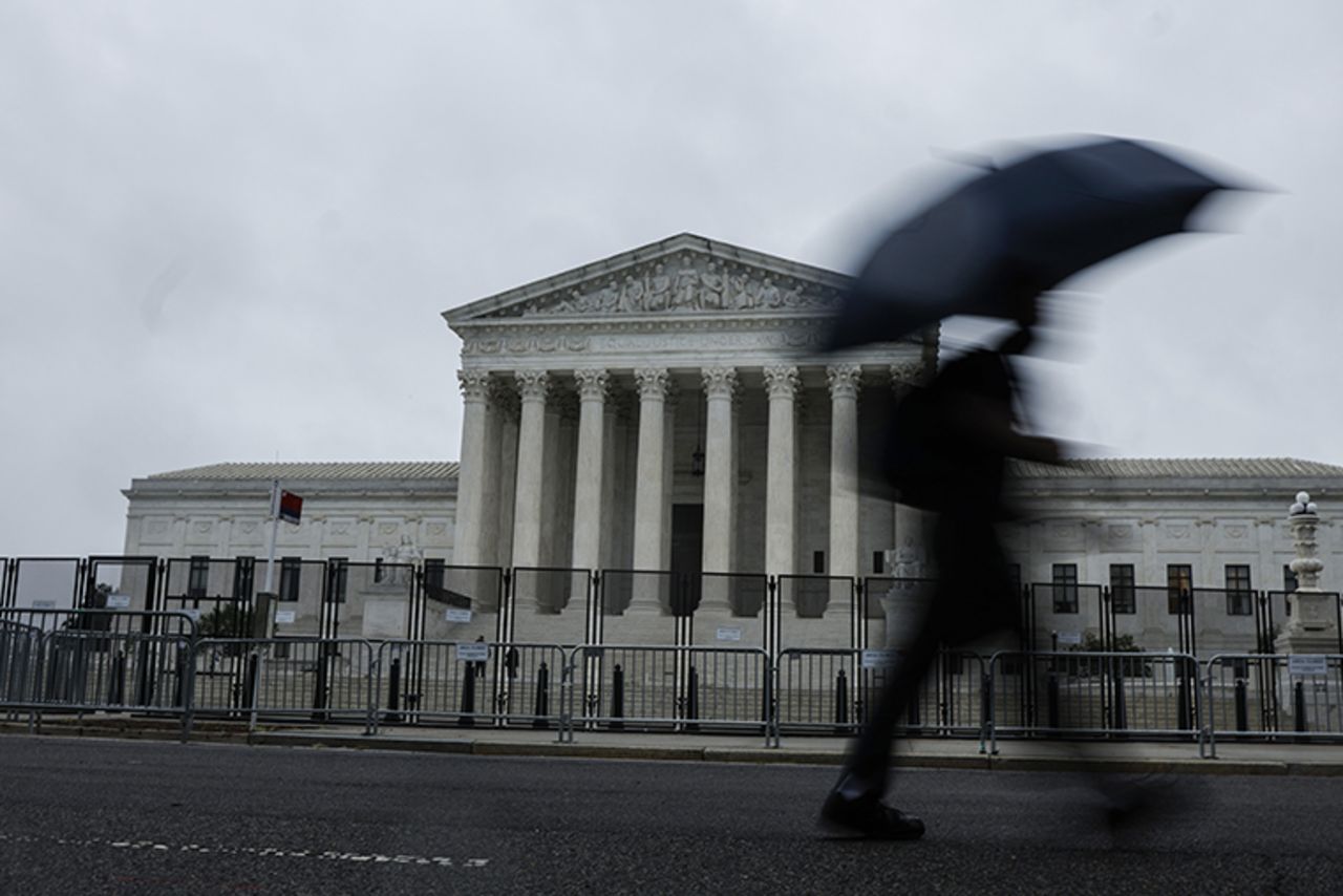 People walk past the U.S. Supreme Court building on June 23 in Washington, DC. 