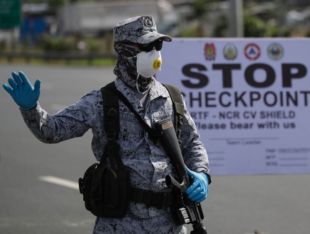 A?Philippine Navy serviceman stands at a toll plaza to conduct motorist verification operations on the border between Cavite province and Paranaque City, Metro Manila, Philippines, on March 17.