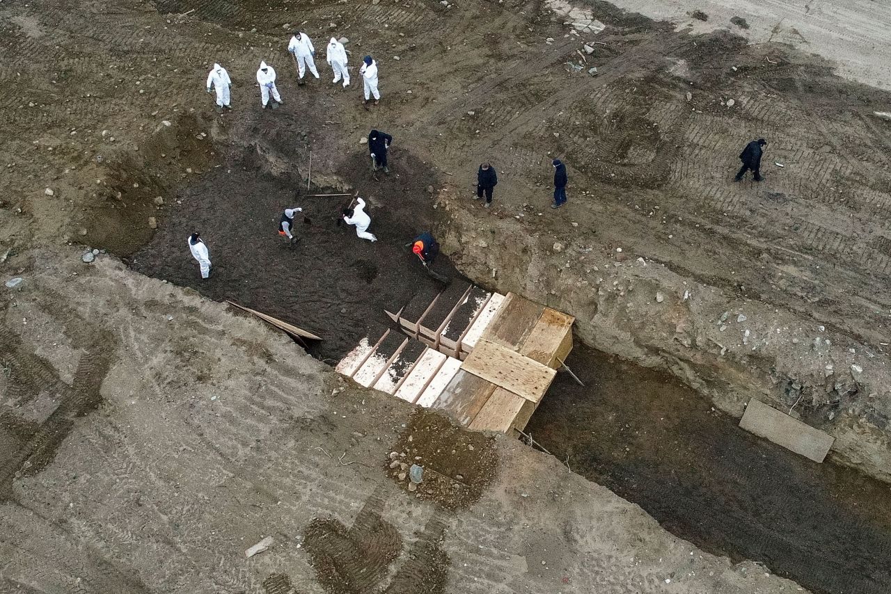 Workers bury bodies on Hart Island, in the Bronx borough of New York, on April 9.