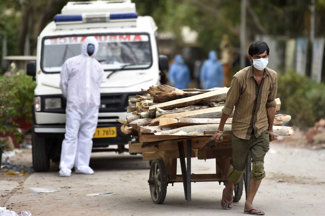 Wood is brought in for the cremation of Covid-19 victims at Sector 94 crematorium, on May 4 in Noida, India.