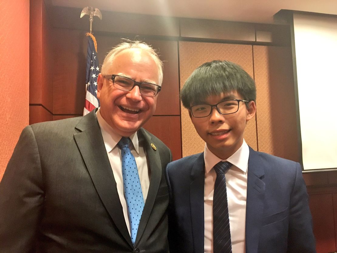 Tim Walz poses for a photo with Hong Kong's now-jailed democracy activist Joshua Wang.