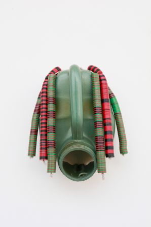 But perhaps Hazoumé is most recognized for his iconic masks made out of used petrol containers. This piece titled “Djé-Bébénon” highlights the dangers young Beninese face when smuggling gasoline over the border, as a way to make money.