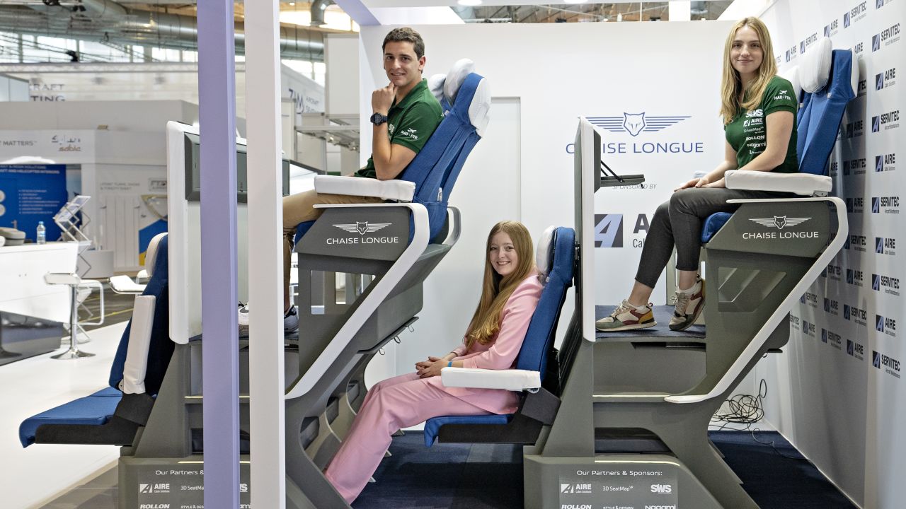 Alejandro Núñez Vicente, left, designed the Chaise Longue double level airplane seat concept. CNN Travel's Francesca Street, center, tested out the latest iteration of the design.
