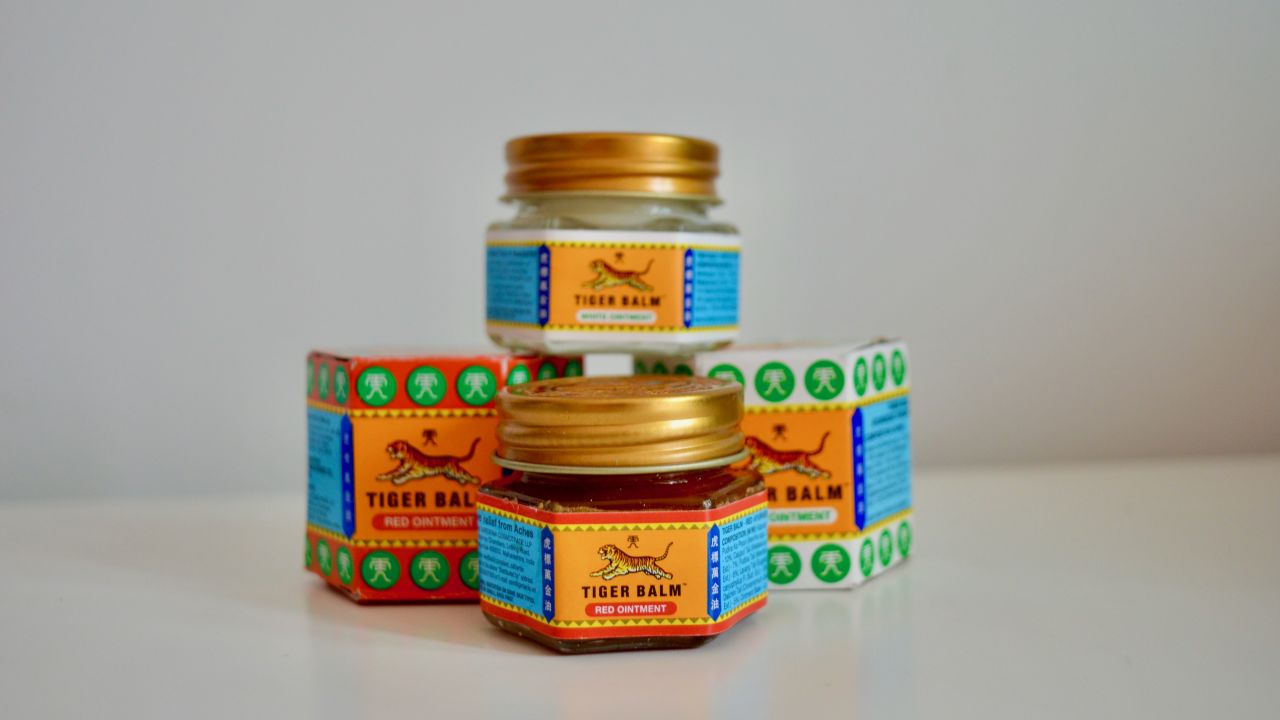 A photo of multiple tins of Tiger Balm on a table