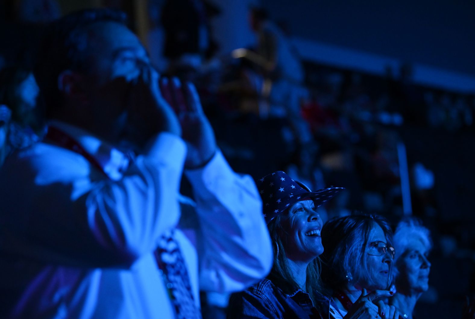 People watch Monday night's speeches at the convention.