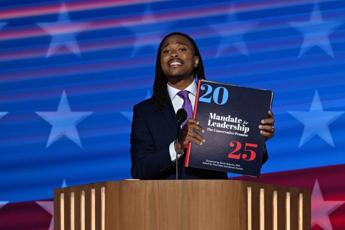 Member of the Pennsylvania House of Representatives Malcolm Kenyatta holds a "Project 2025" book while speaking at the Democratic National Convention in Chicago on August 20, 2024.