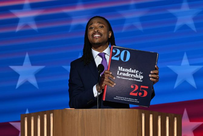 Pennsylvania state Rep. Malcolm Kenyatta holds a Project 2025 book while speaking at the convention on Tuesday. <a href="https://static.project2025.org/2025_MandateForLeadership_FULL.pdf" target="_blank">The 920-page document</a> was organized by The Heritage Foundation think tank and developed in significant part by people who served in Donald Trump’s administration. Its proposals for right-wing policies and a radical reshaping of the executive branch <a href="https://www.cnn.com/politics/live-news/dnc-democratic-national-convention-08-20-24#h_1fe204f1f743bf7b6553a835427a9beb">have become frequent targets of Democratic criticism</a>.