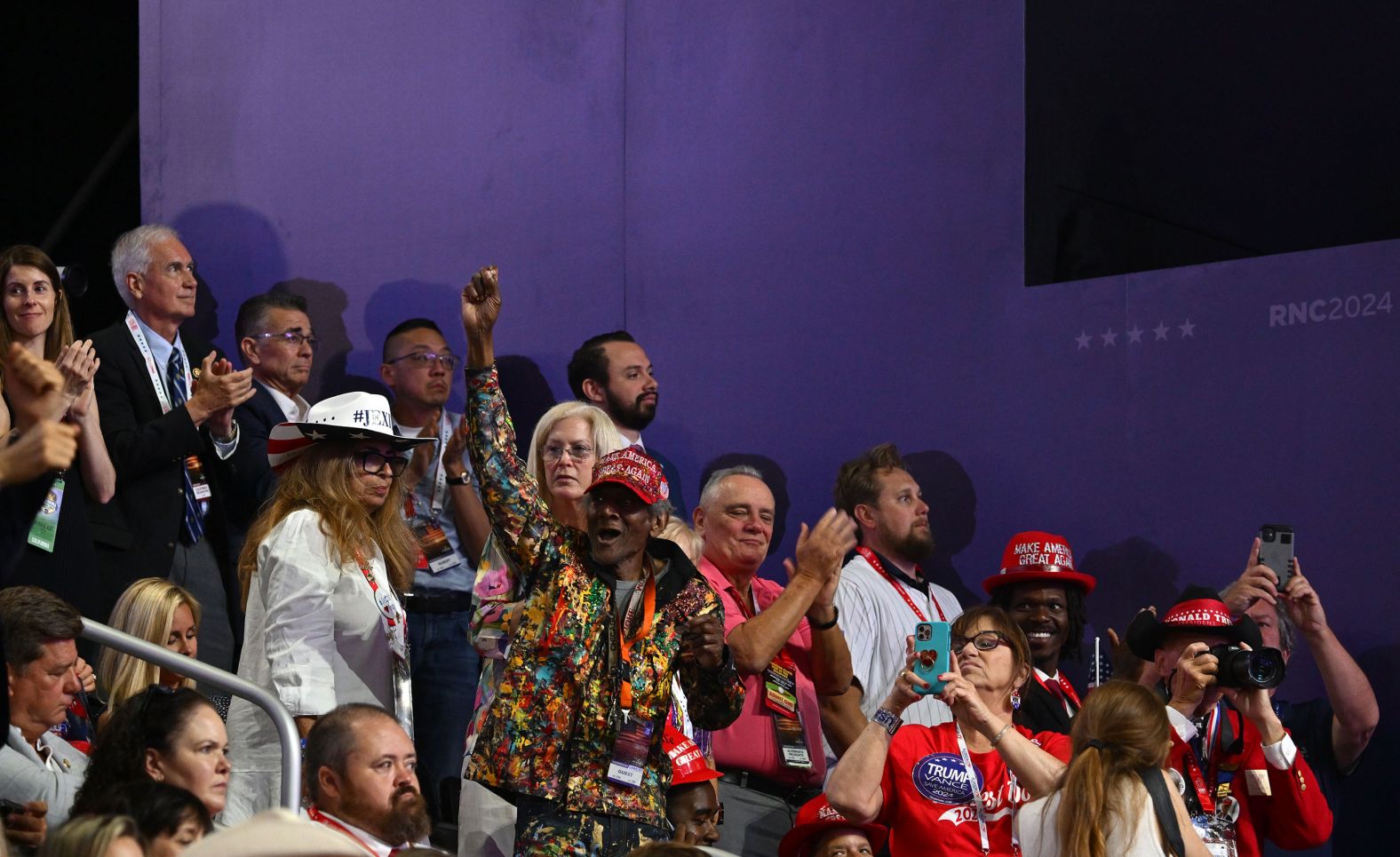 A Trump supporter cheers on the former president inside the Fiserv Forum.