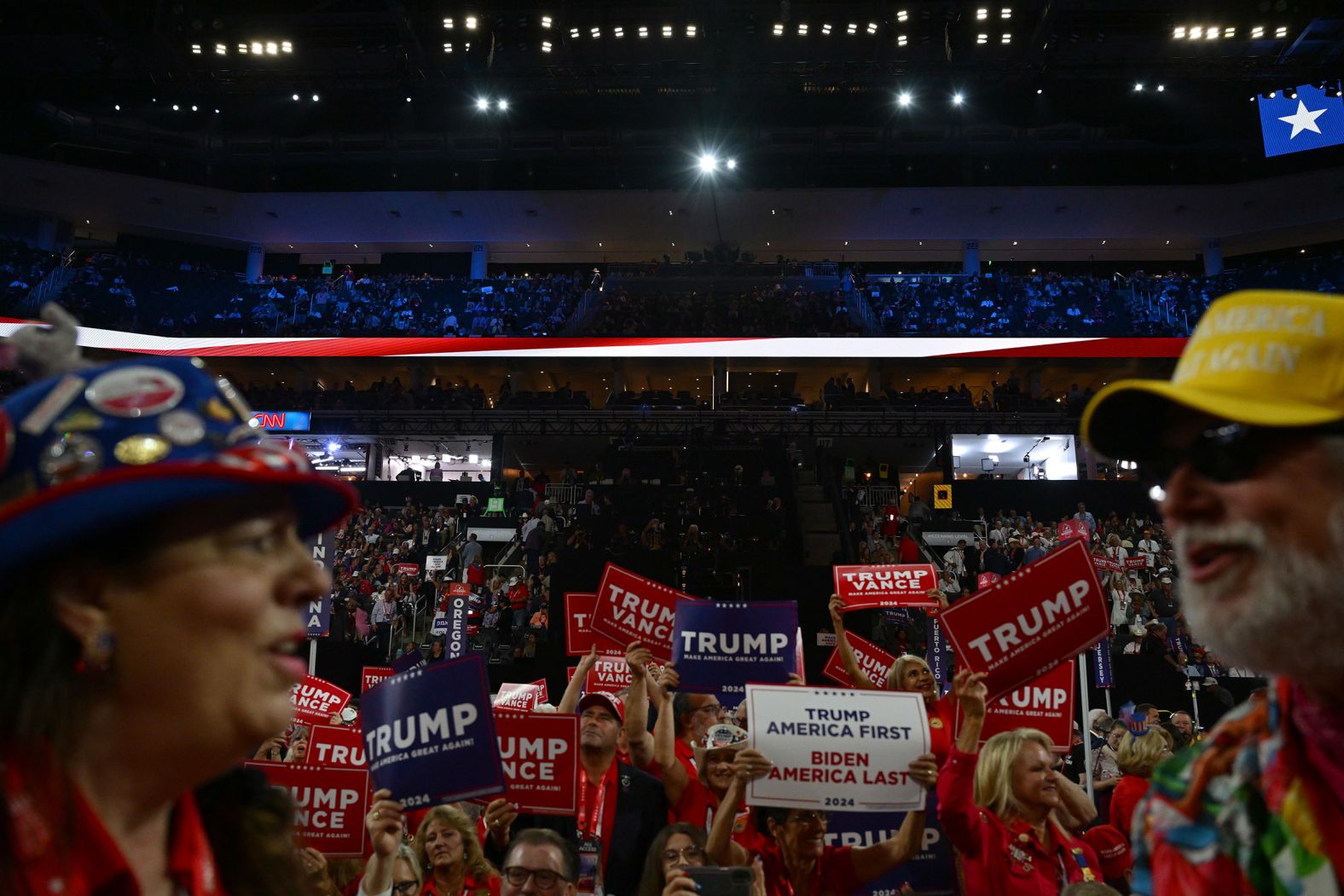 Trump supporters hold signs on the convention floor on Tuesday.