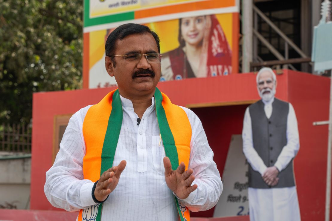 Varanasi BJP President Dileep Patel at his office, in front of a Modi cutout.