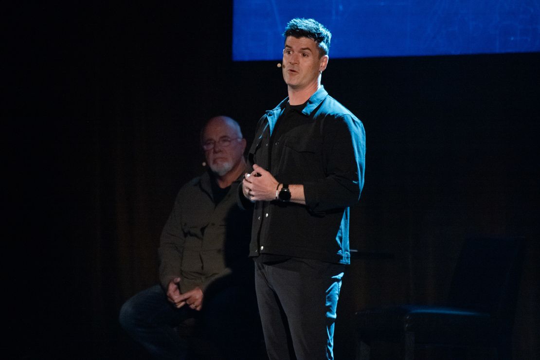 John Delony speaks (right) during an event with Dave Ramsey (left) at the Fox Theatre in Atlanta, on April 25.