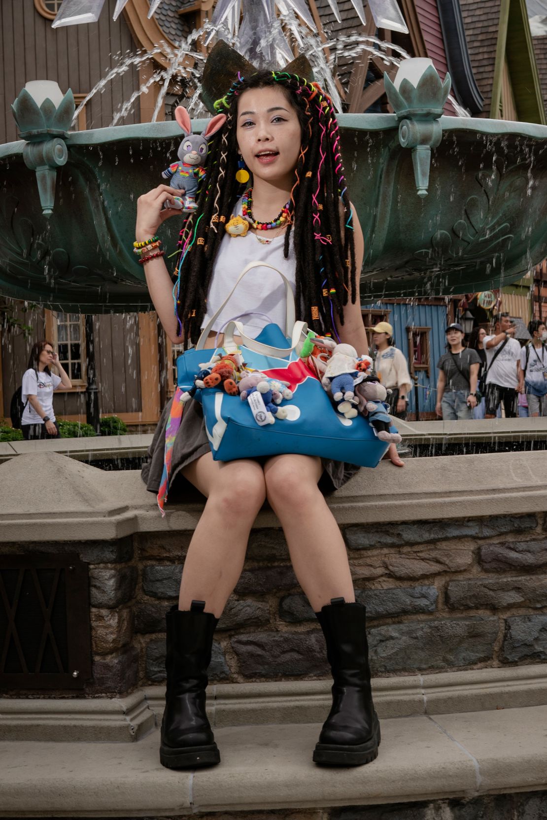 Ankh Wong poses for a picture in front of the snowflake fountain popular with influencers in the World of Frozen, Hong Kong Disneyland's latest attraction.