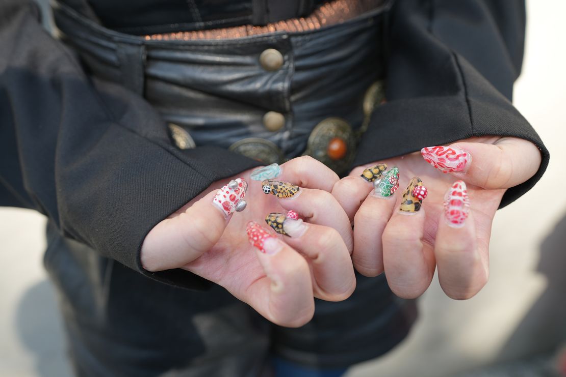 Attendee Natsumi Maso shows off elaborate nail art.