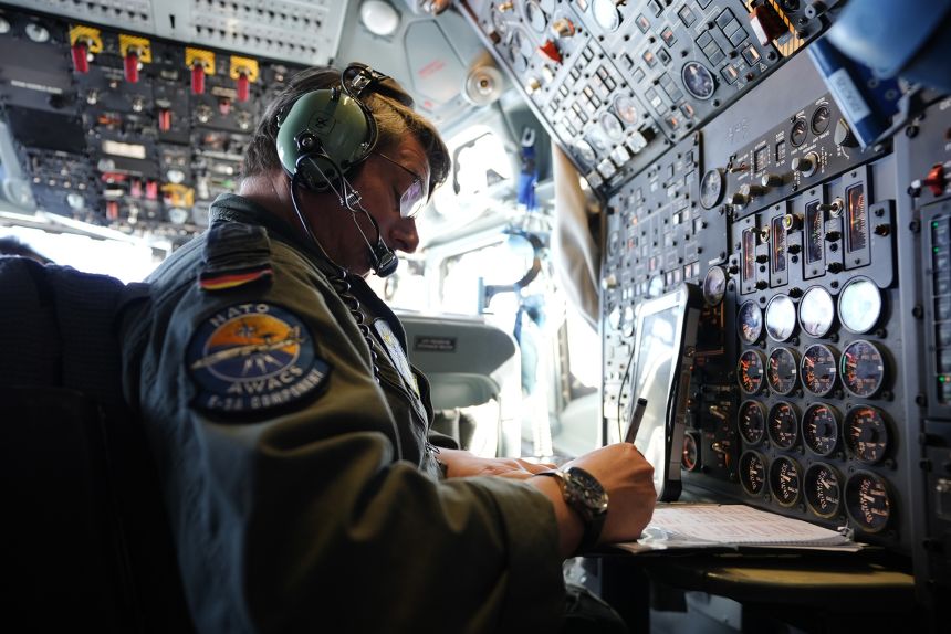 An E-3 Sentry crew member prepares for an hours-long surveillance flight.