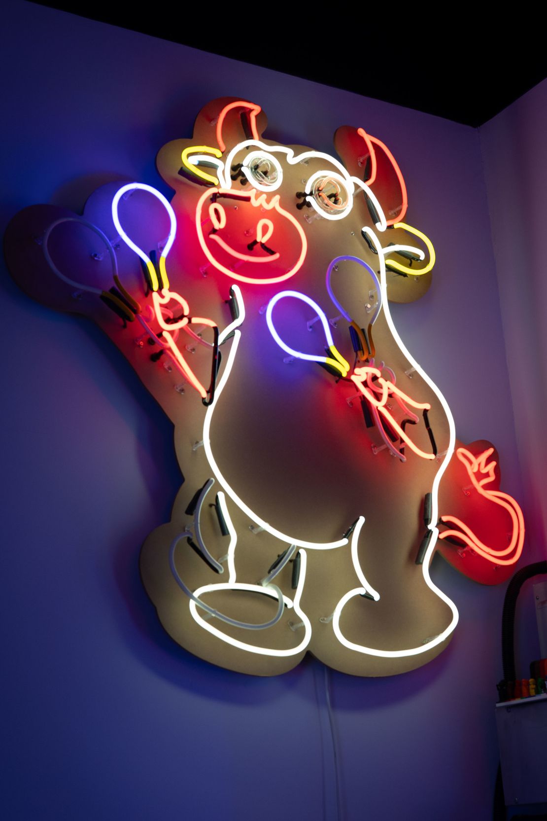 A neon sign titled “Maracas Fiesta” hangs on the wall of Jive Lau's studio.