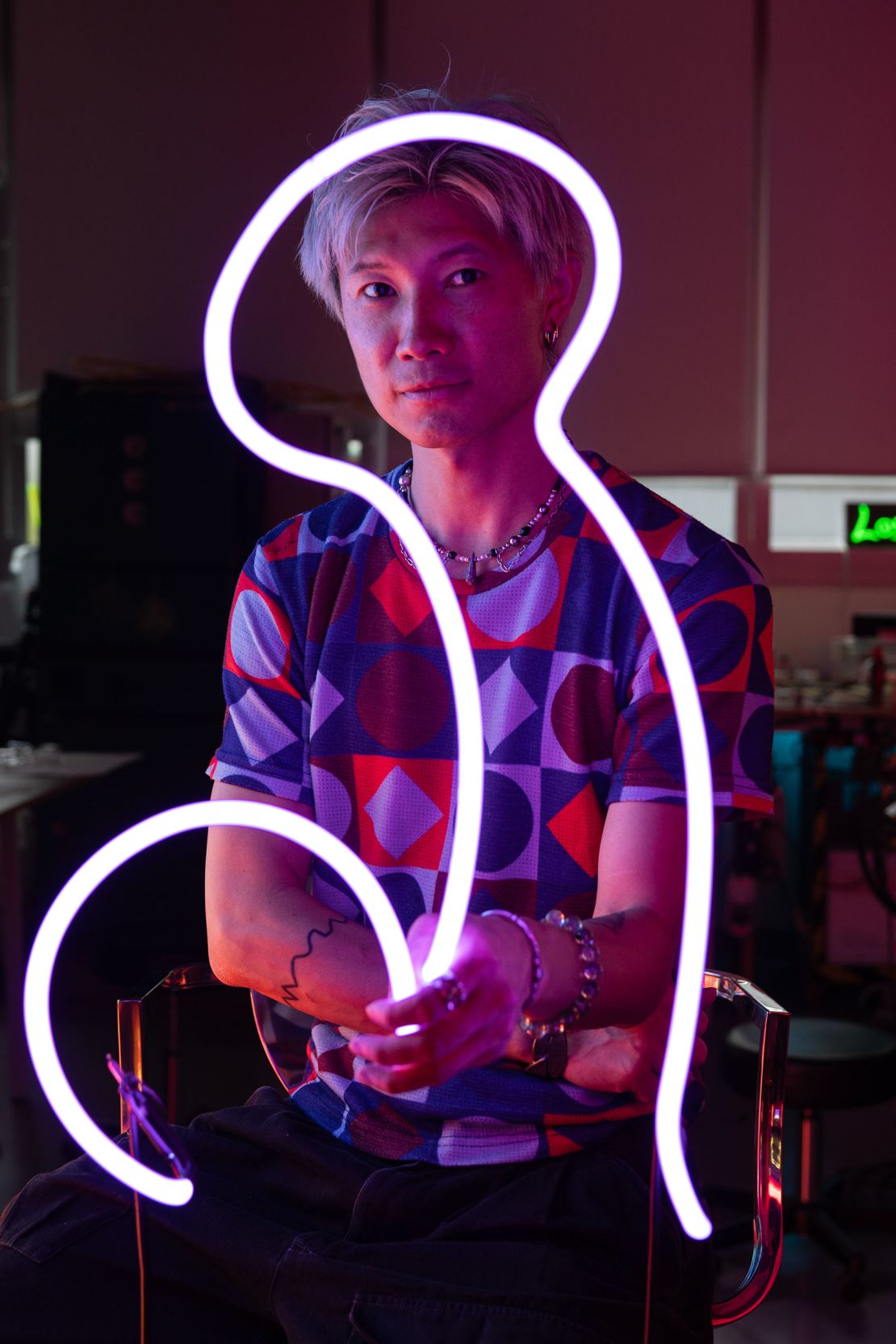 Jive Lau holds an illuminated neon light at his studio in Hong Kong, China, on May 16.