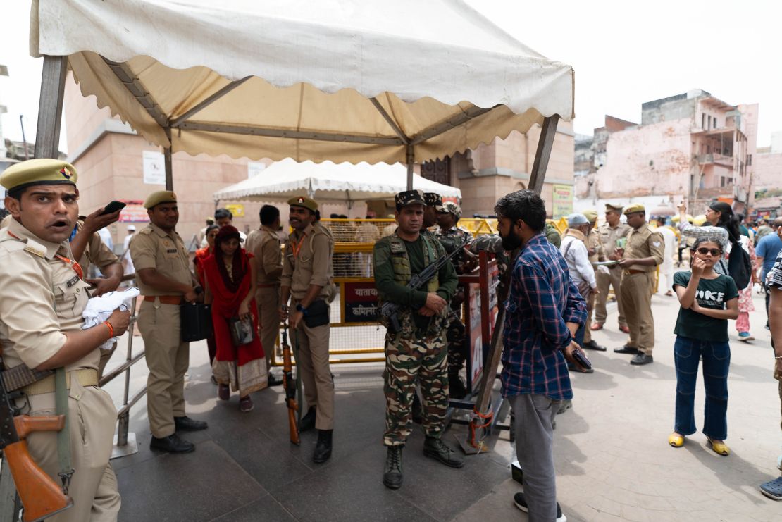 Guards patrol the street outside the Gyanvapi Mosque.