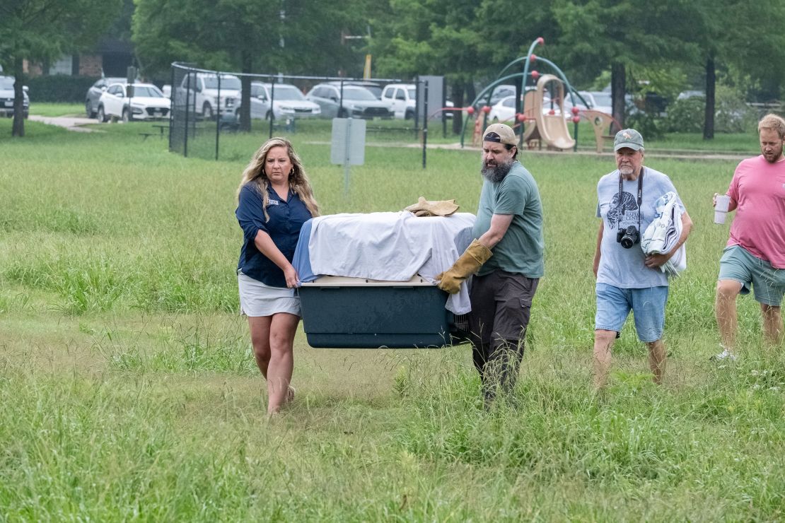 Officials with the Blackland Prairie Raptor Center carry a crate holding the surviving eaglet on June 2, 2024.