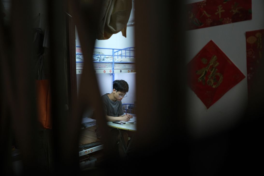 Roy, a 15 year old resident of a subdivided flat that he shares with his mother  in Sham Shui Po, Hong Kong, on July 4, 2025.