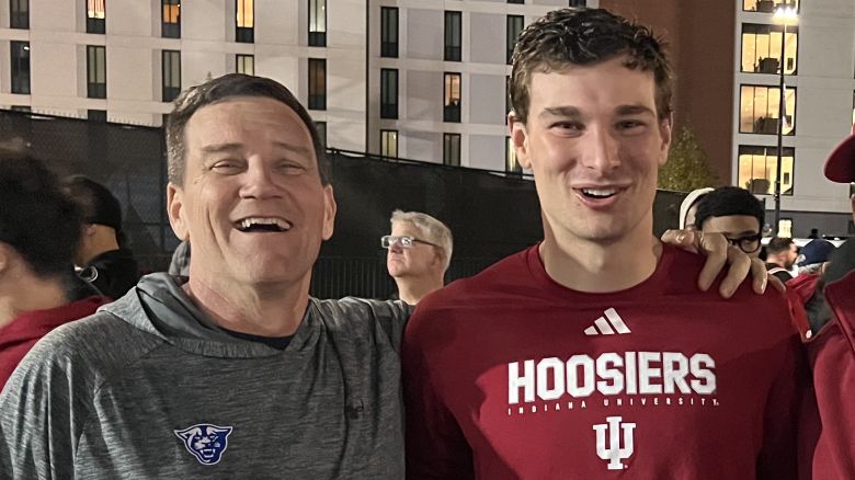 Coach Dave Dunn, left, celebrates with Fernando Mendoza, second left, Mendoza's father, also called Fernando, and his brother Alberto, right, after the Hoosiers beat Maryland 55-10 last month.