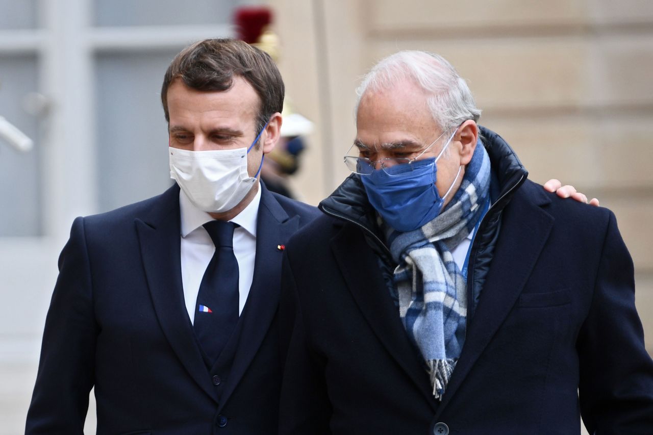 French President Emmanuel Macron, left, welcomes Angel Gurría, secretary-general of the Organization of Economic Cooperation and Development, in Paris on December 14.