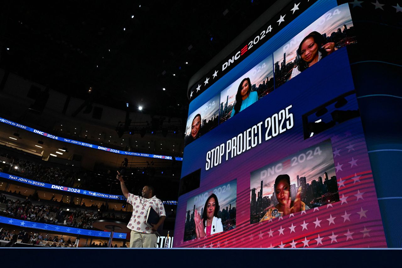 Comedia Keenan Thompson carries a book referencing Project 2025 while addressing the Democratic National Convention in Chicago on August 21. 