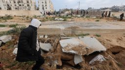 Palestinians check damaged graves at a cemetery following an Israeli raid in Khan Younis, Gaza, on January 17.