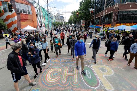 People walk around Seattle's Capitol Hill Autonomous Zone on Sunday, June 14.
