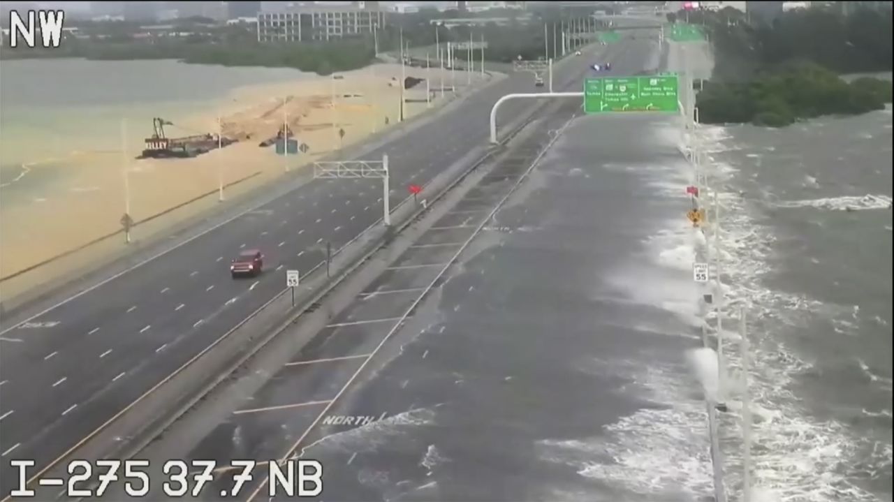 Vehicles navigate over a flooded Interstate 275 in Tampa Bay on Wednesday before it was closed.