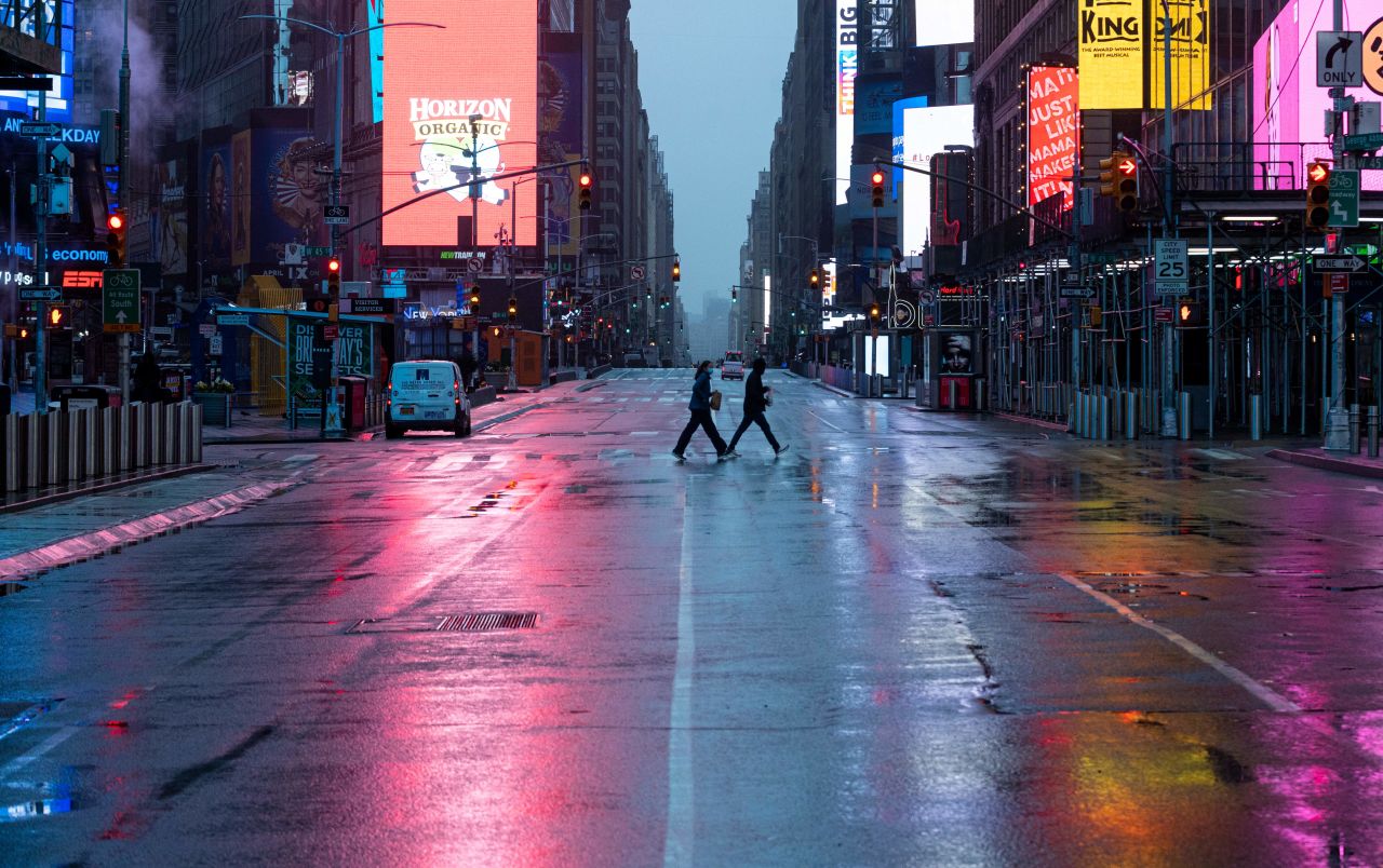 People cross a street in New York City's Times Square on April 13.