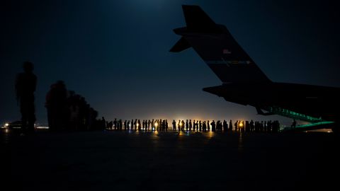 An air crew prepares to load evacuees aboard an aircraft in support of the Afghanistan evacuation at Hamid Karzai International Airport on August 21 in Kabul, Afghanistan. 