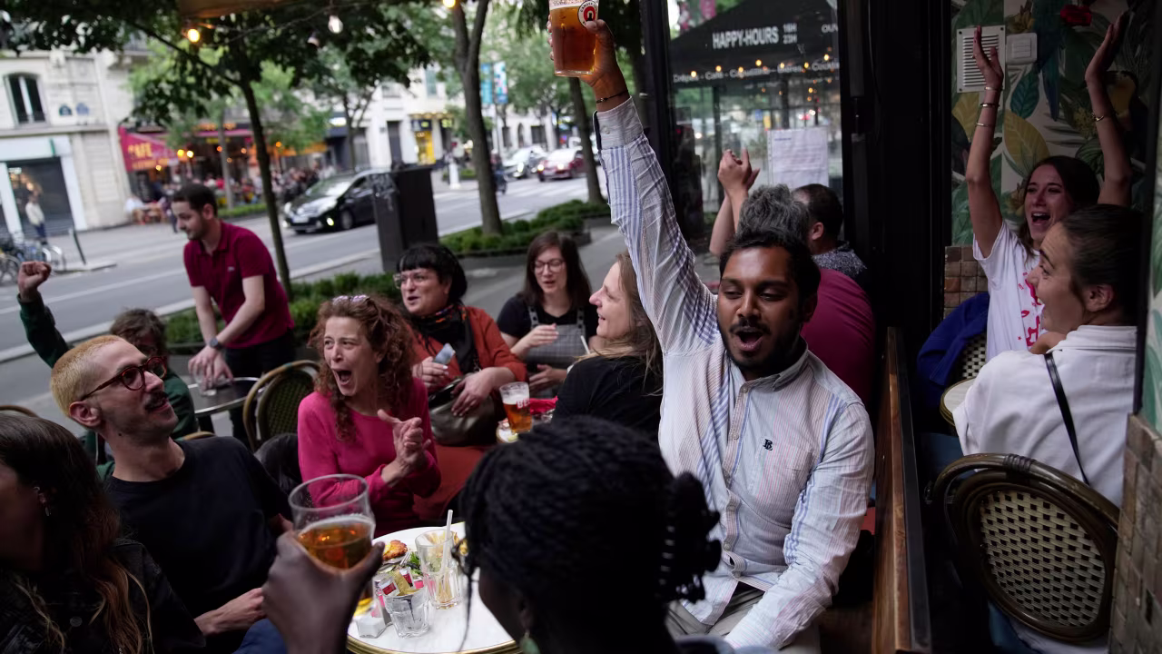 People react to the projection of results in Paris. 