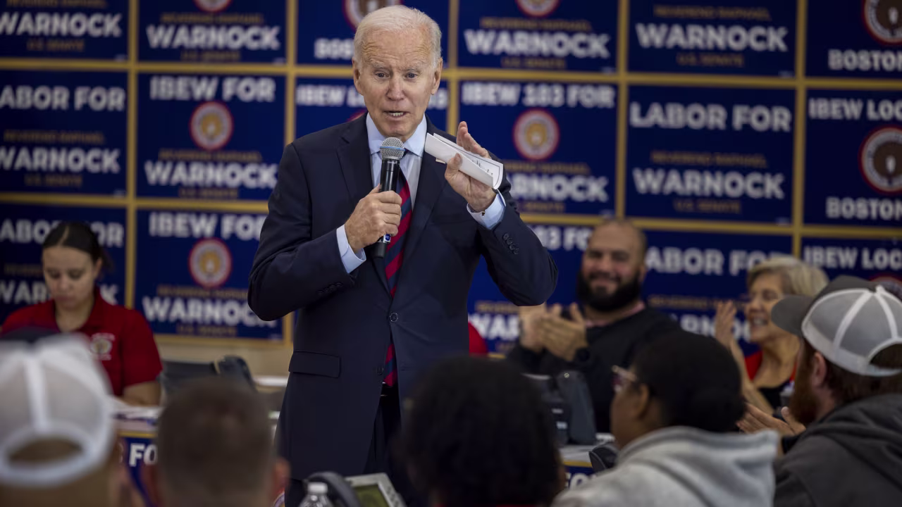 President Joe Biden speaks to volunteers in Boston working at an International Brotherhood of Electrical Workers phone-banking event Friday for US Sen. Raphael Warnock.